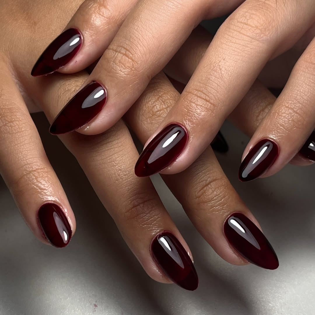 Glossy oxblood almond nail set, deep burgundy high-shine finish